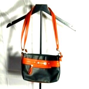 Black ROSETTI Trendy shoulder bag w/tan trim. Adjustable shoulder strap. Zip